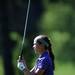 Pioneer's Hyunji Kim watches her ball after teeing during golf regionals at the University of Michigan Golf Course on Thursday. Melanie Maxwell I AnnArbro.com
